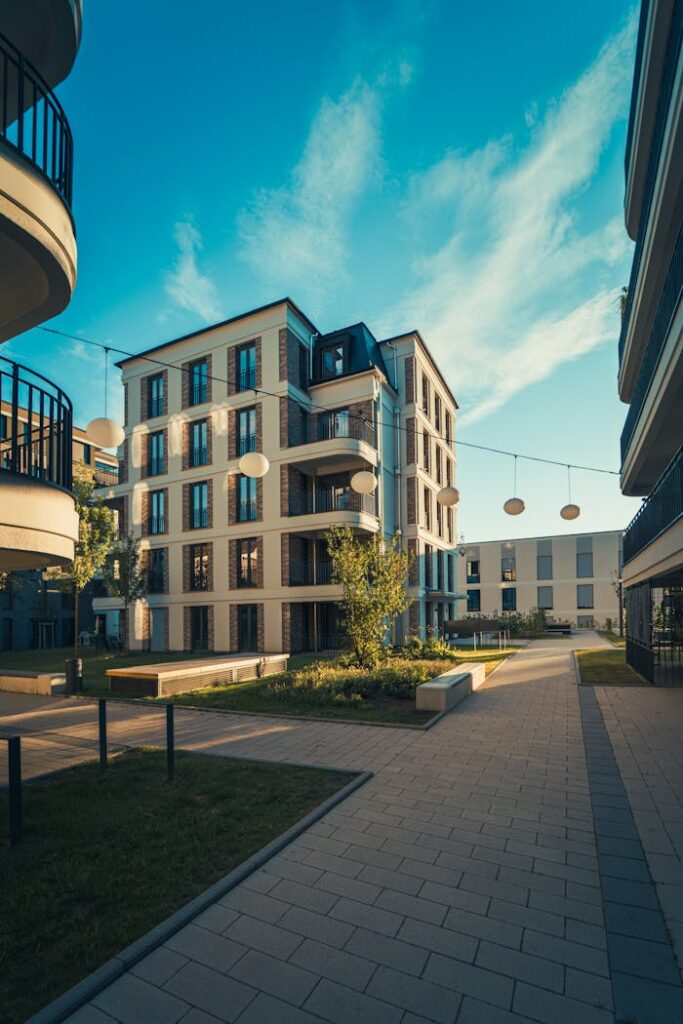 Mastering the First Impression: Your intriguing post title goes here Modern apartment complex under clear blue skies, showcasing contemporary architecture and urban living.